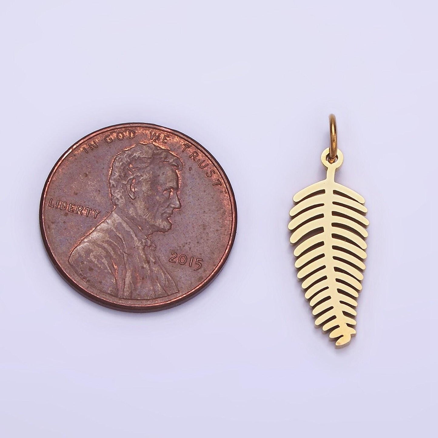 Dainty gold palm tree leaf charm in stainless steel p-1400
